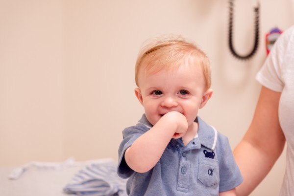 Baby boy smiling in exam room